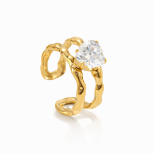 Gold ring with clear stone on white background