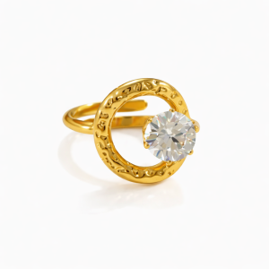 Gold halo ring with textured circular design and clear cubic zirconia stone on a white background