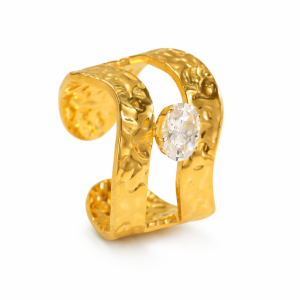 Hammered gold cuff ring with oval crystal centerpiece on a clean white background